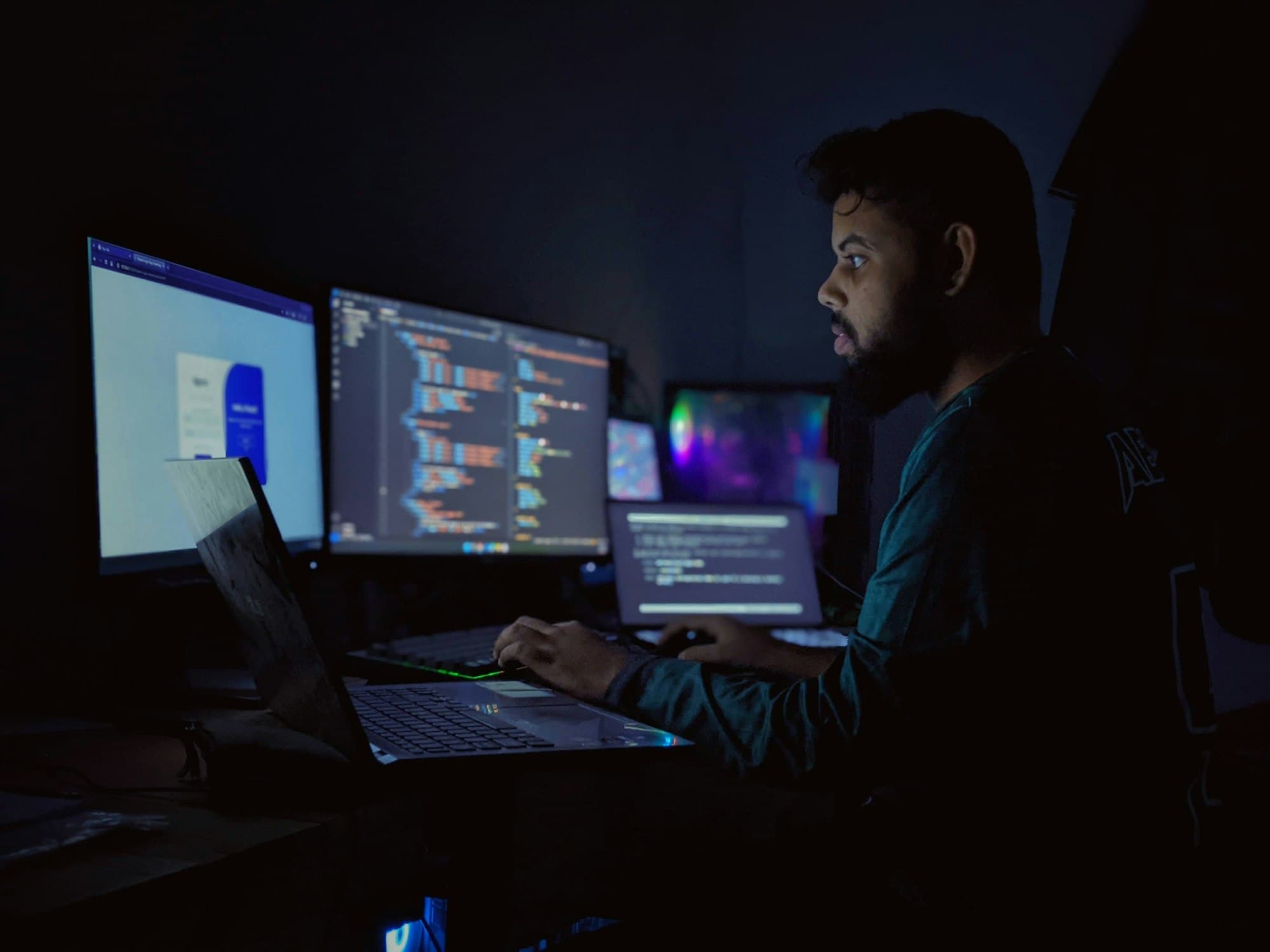 Security researcher analyzing code on multiple monitors